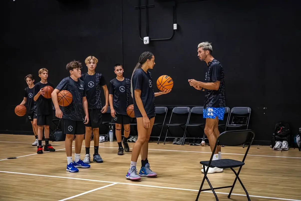 Jordan coaching a group of young players on the floor