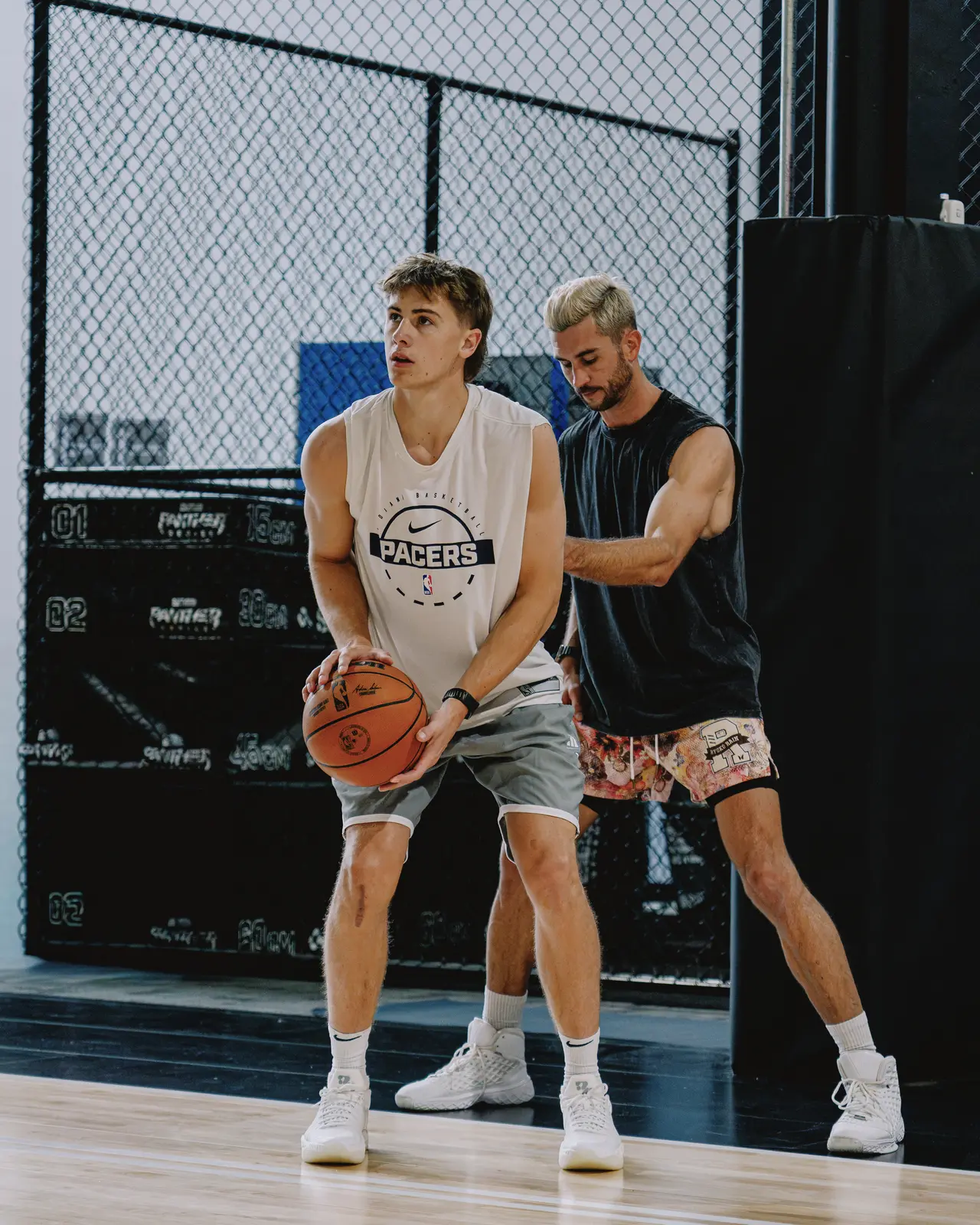 Jordan Lawley working one on one with a player on the floor