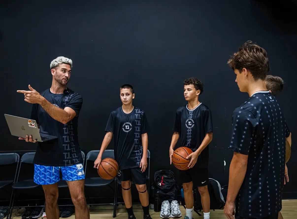 Jordan Lawley talking a group of players through film on a laptop