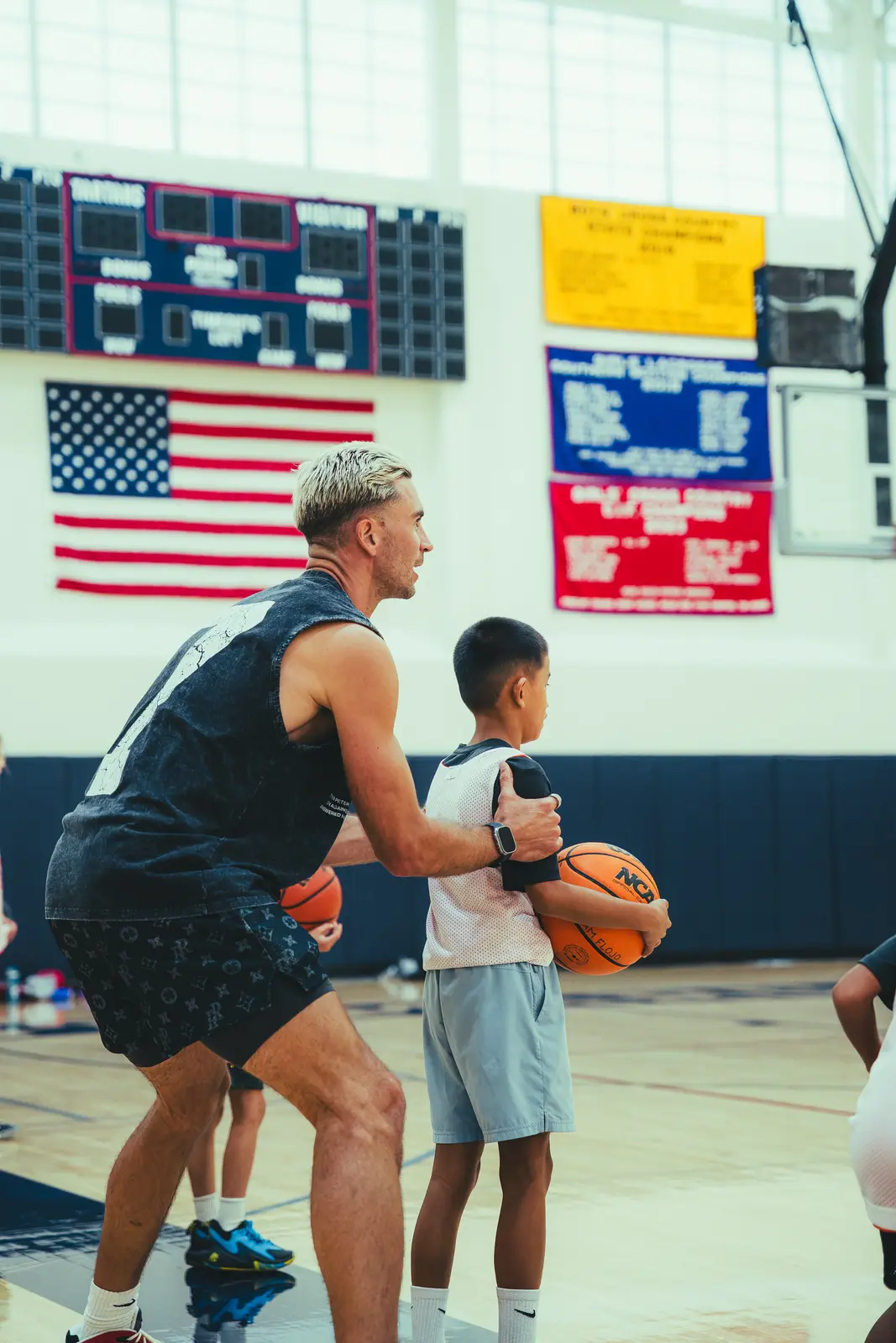 Jordan Lawley with a hand on a young player's shoulder