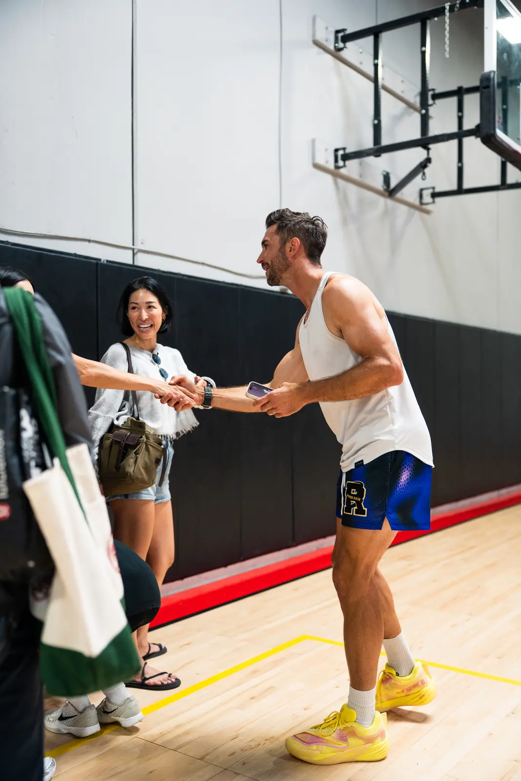 Jordan Lawley greeting a parent courtside at Boombase