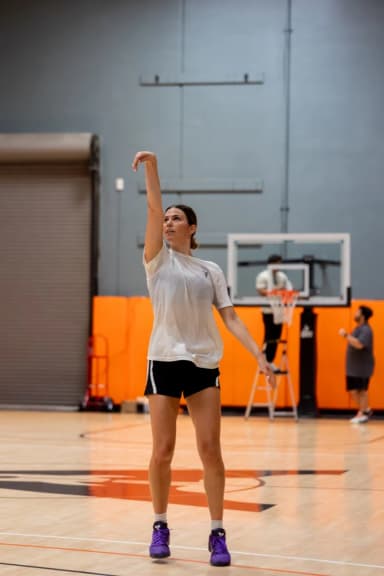 Rising into a jumper with a full follow-through.